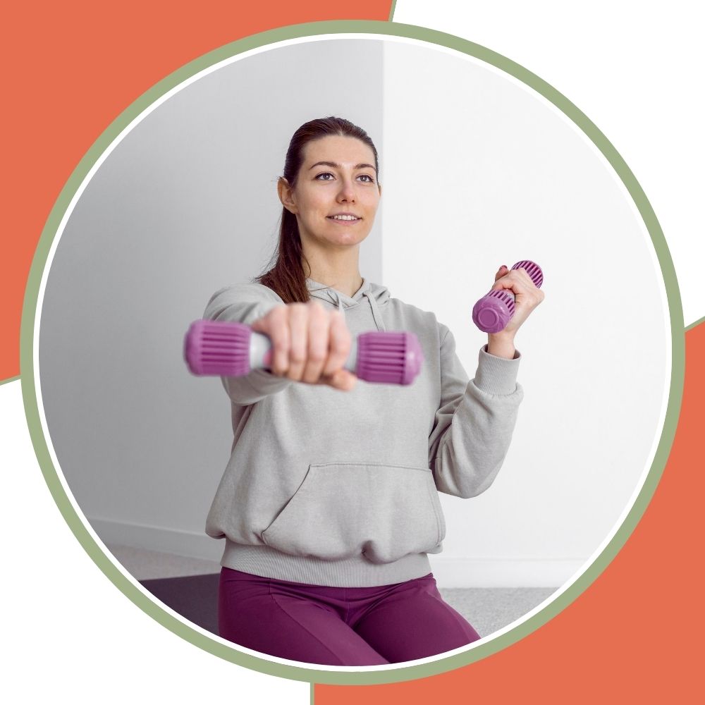 A woman in a light gray hoodie and purple leggings holds two small purple dumbbells in a circular frame, with a coral and white graphic background.